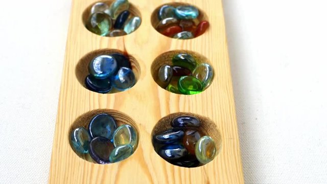 wooden mancala and stones,
