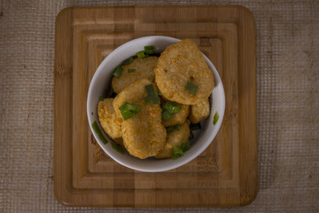 Chicken nuggets on  a wooden background and rustic fabric . Top view