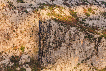 Sunlight on Steep Mountain Cliff