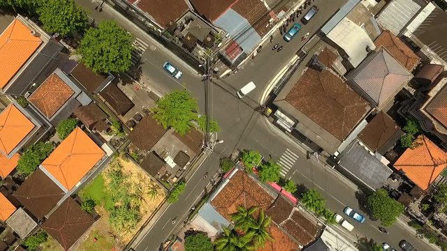 Aerial top view of crossroads in Seminyak, Bali, Indonesia on sunny summer day