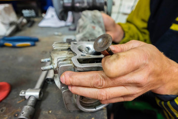 grinding the cylinder heads of the scooter. motorcycle repairs