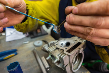 grinding the cylinder heads of the scooter. motorcycle repairs