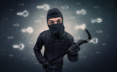 Burglar standing with tools in his hand.