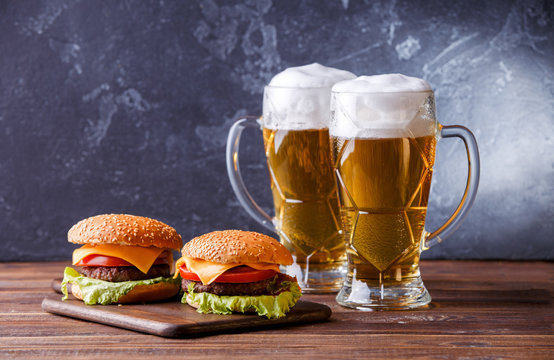 Photo of two hamburgers, glasses with beer