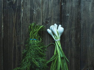 close up bunches of fresh raw green onion and dill flat lay