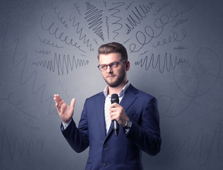 Businessman speaking into microphone with scribbles over his head 