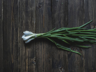 flat lay overhead isolated green onion on a wooden table
