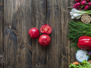 Fototapeta na wymiar sliced fresh tomatoes with other vegan food flat lay on a wooden table