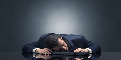 Young businessman fell asleep at his workplace with copy space