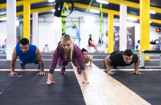 young healthy people doing pushups