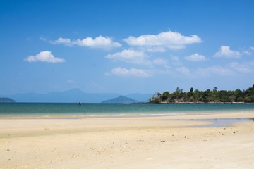 Fototapeta na wymiar Sand beach with green sea water and blue sky. Islands in Andaman Sea, Thailand.