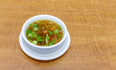 Top view of a delicious dietary vegetable soup with parsley leaves