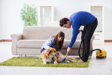 Husband cleaning house from dog fur