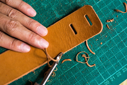 Leather work product with raw material on green board
