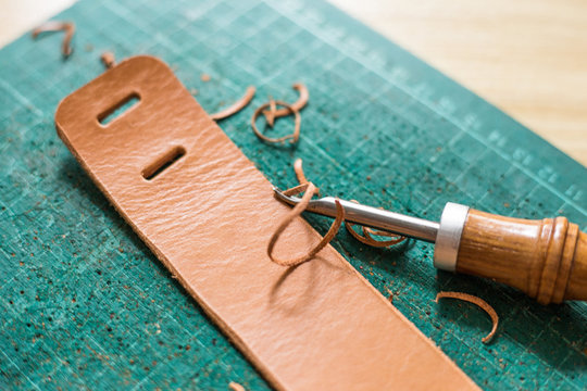 Leather work product with raw material on green board