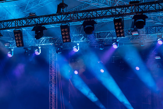 professional lightning equipment. spotlights over concert stage. bright blue lights