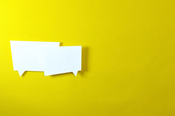 two irregular text bubbles on yellow background