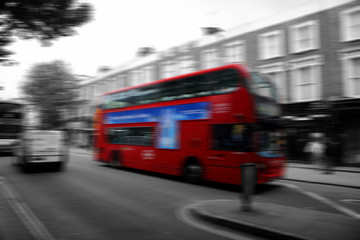 Iconic London red double decker bus, abstract with motion blur and selective color