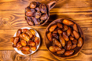 Date fruits on a wooden table. Top view