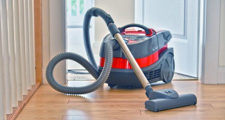 Canister vacuum cleaner for home use on the floor