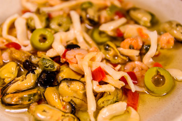 Ceramic plate with the different sea food and olives