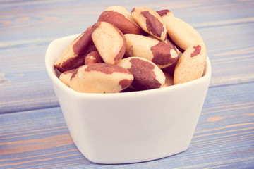 Vintage photo, Heap of brazil nuts in dish as source of natural minerals and vitamin