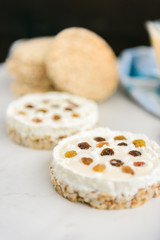 Homemade healthy sandwiches. Crisp bread with cottage cheese, baked milk and raisins on light background.