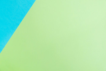 Pastel colored paper flat lay top view, background texture, blue and green.