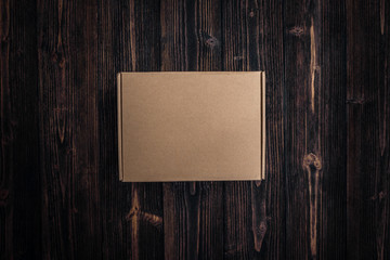 Top view of empty Package brown cardboard box or tray on wooden background,