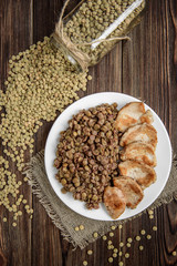 Grilled chicken with lentils on white plate. Healthy dinner
