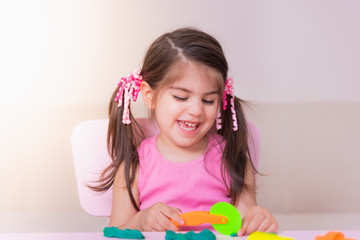 Portrait of Cute girl playing with toys for playdough