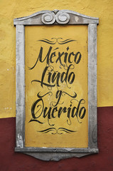 Mexico Lindo y Querido, Mexico Beautiful and beloved spanish text, graffiti in a colonial frame, wall.