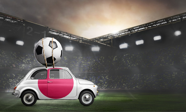 Japan flag on car delivering soccer or football ball at stadium