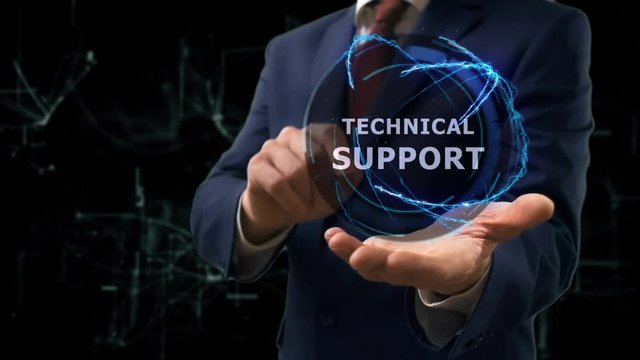 Businessman shows concept hologram Technical support on his hand. Man in business suit with future technology screen and modern cosmic background