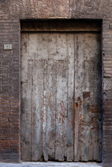 Fototapeta na wymiar Old wooden door in Sienna