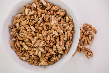 bowl of whole wallnuts on white background