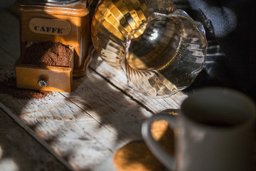 close-up of a coffee grinder with coffee in a country atmosphere