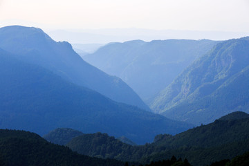 Mountains and valleys fade into distant horizon