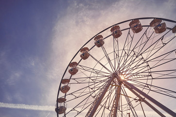 Fototapeta premium Vintage toned picture of a Ferris wheel at sunrise.