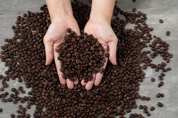 coffee beans heart shape in hand hold with love for decoration