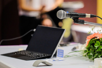 business laptop and microphotone at podium on seminar conference education