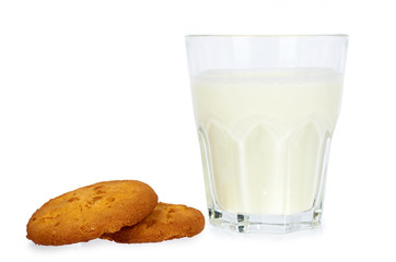 Glass of milk and homemade cookies isolated on white background