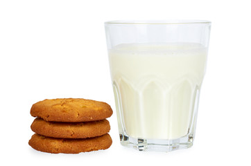 Glass of milk and homemade cookies isolated on white background