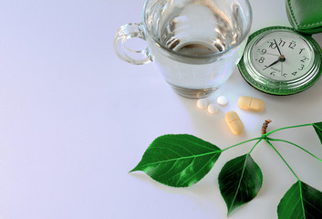 Morning taking pills, treatment, a glass of clean water, time, health,.