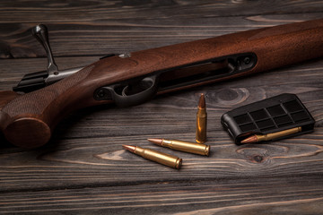 Hunting rifle on a wooden background