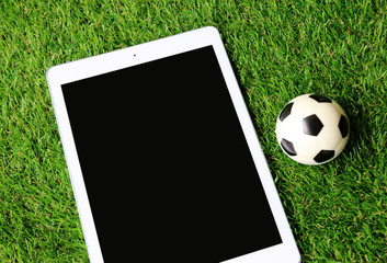 tablet and football on Green grass Concept Football 2018 World Championship