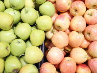 green and red apples in a box