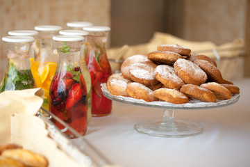 fruit drinks and cookies on the table
