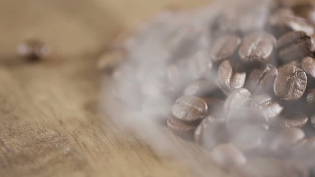 Fried coffee beans, delicious aroma, covered with smoke, roasted grain cafe flavor taste hot fresh smell morning.