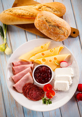 Breakfast - sausages, yellow cheese and vegetables